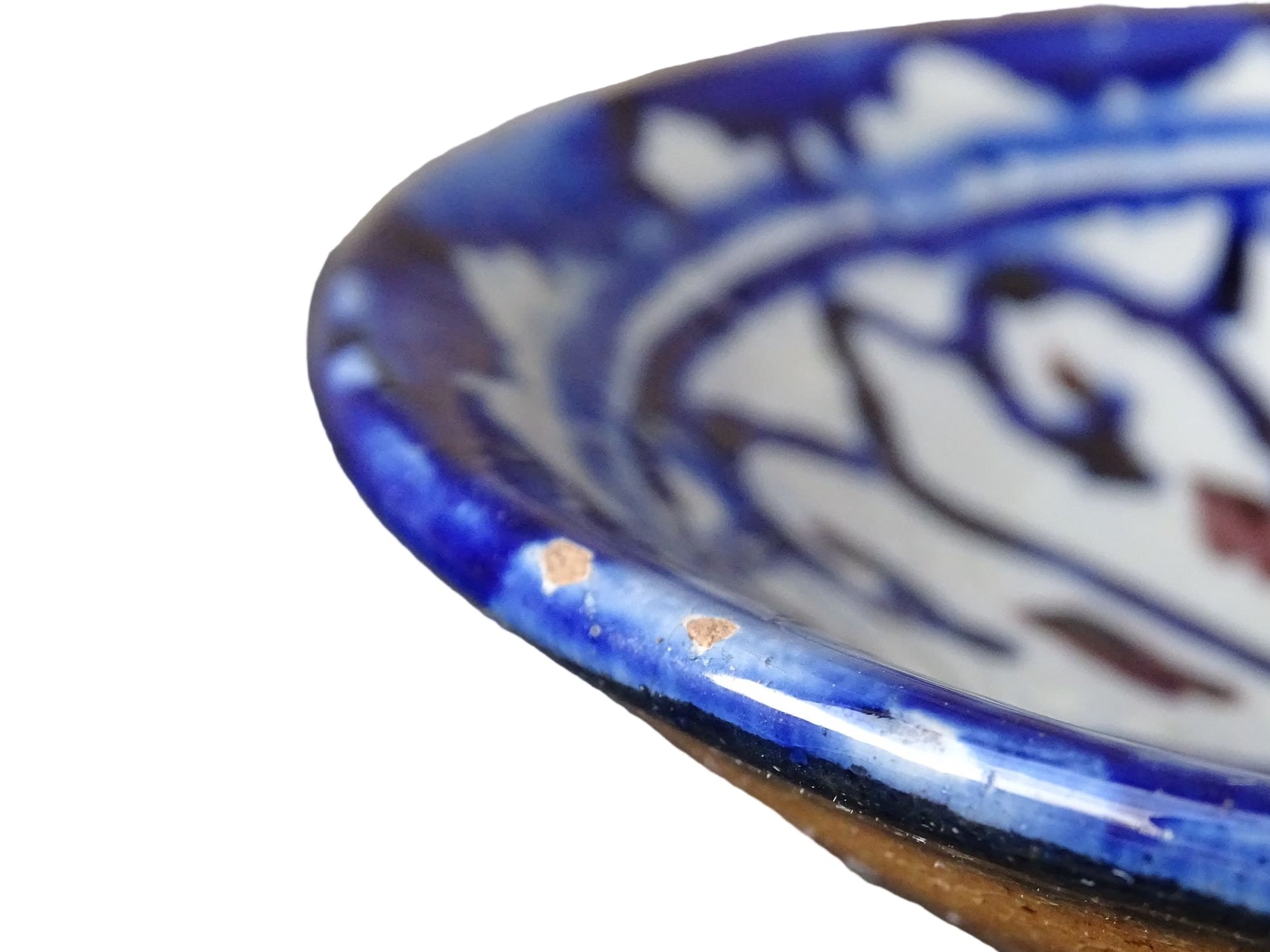 Small vintage ceramic dish with a blue glaze pattern with flecks of red. Moroccan earthenware dish with a hand-painted design.