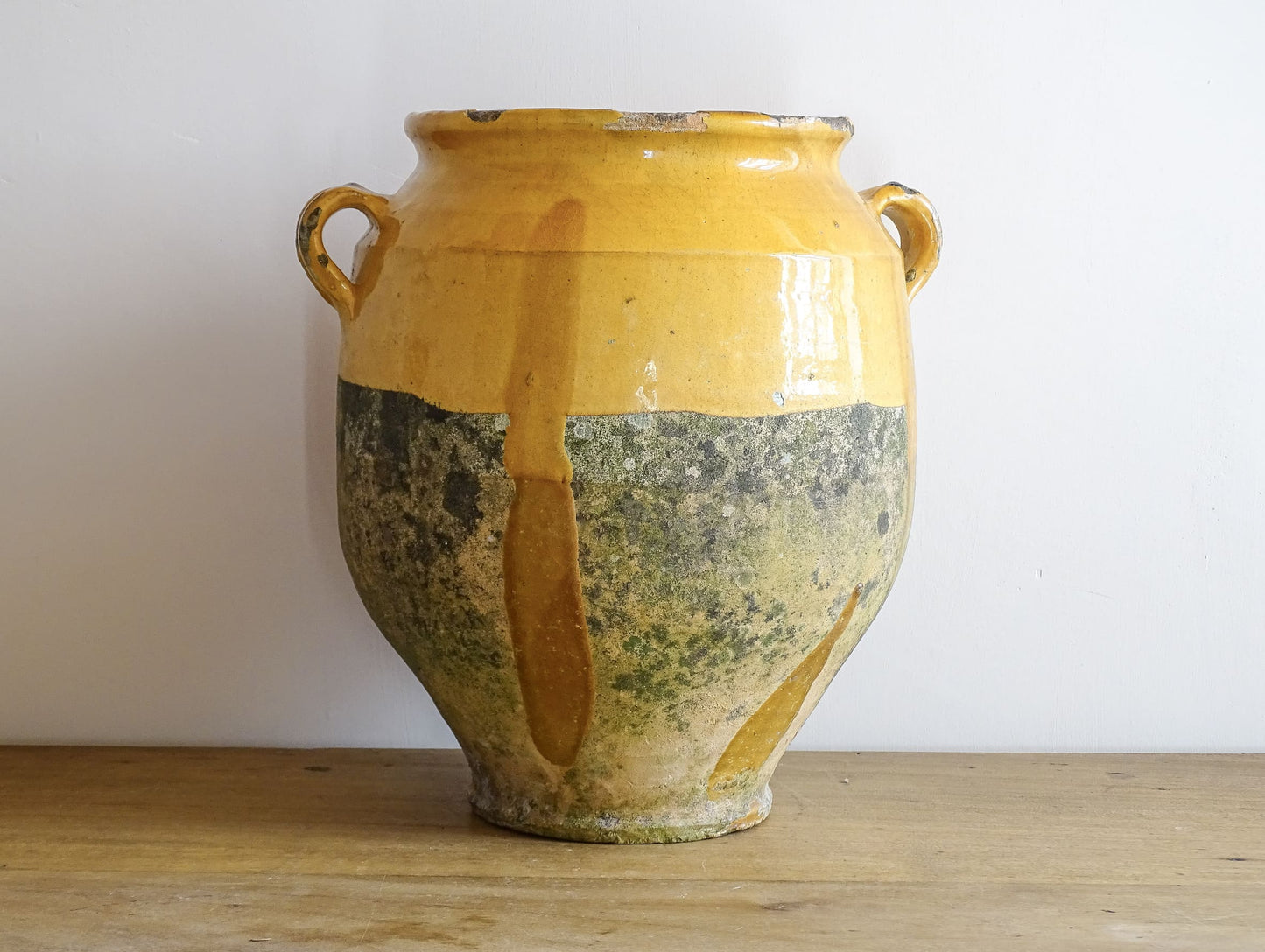 French antique confit pot with mustard yellow glaze. Terracotta jar with two handles. 