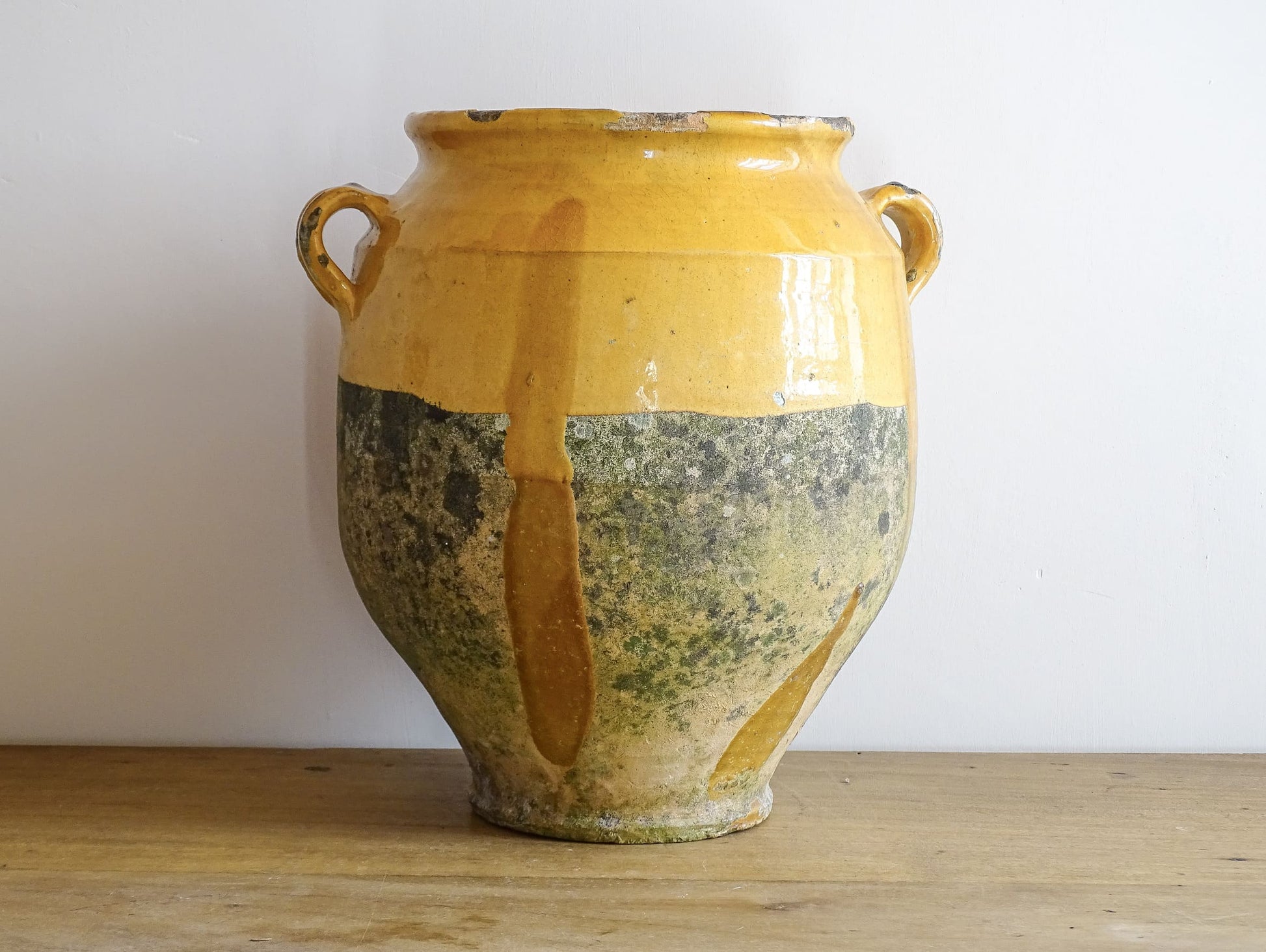 French antique confit pot with mustard yellow glaze. Terracotta jar with two handles. 