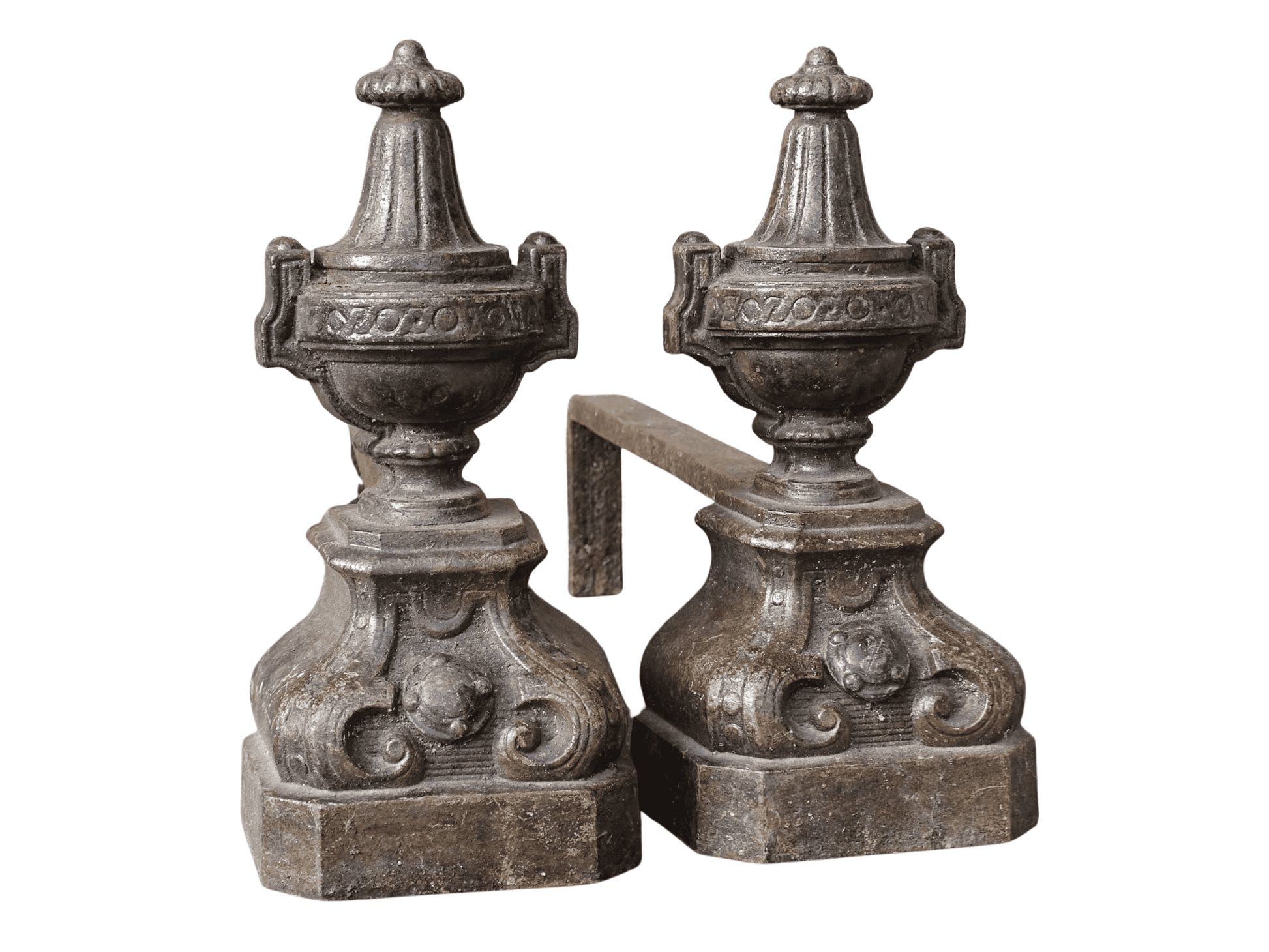 Pair of French antique cast iron andirons or fire dogs with a classical style. Each andiron is topped with an urn-shaped finial, accented by moulded details and a fluted form that evokes neoclassical architectural design. The bases are decorated with scrolling motifs and small medallions. 