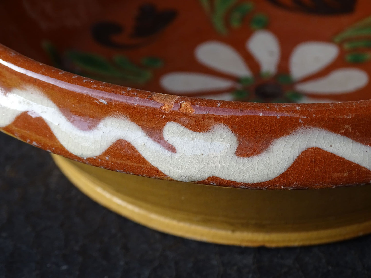 French vintage pottery bowl from Alsace. Glazed terracotta dish with painted flowers.