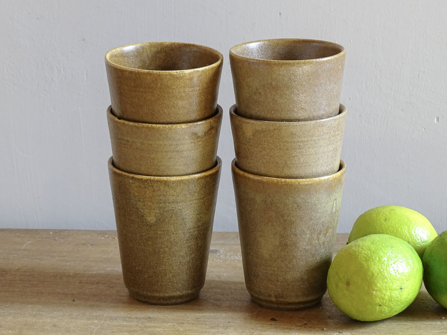 Set of six rustic vintage stoneware cups or pottery tumblers by Digoin in neutral tones. 