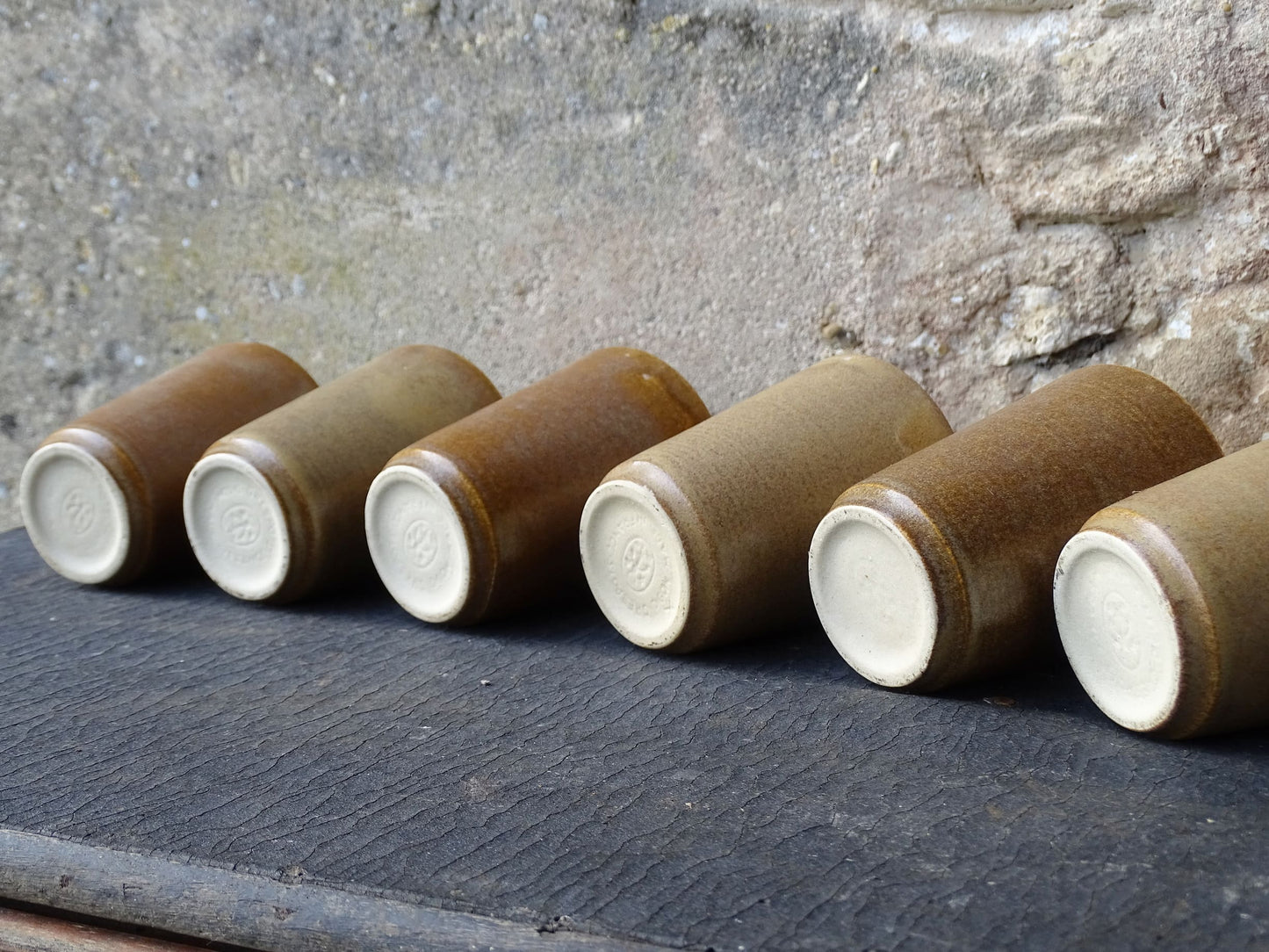 Set of six rustic vintage stoneware cups or pottery tumblers by Digoin in neutral tones. 