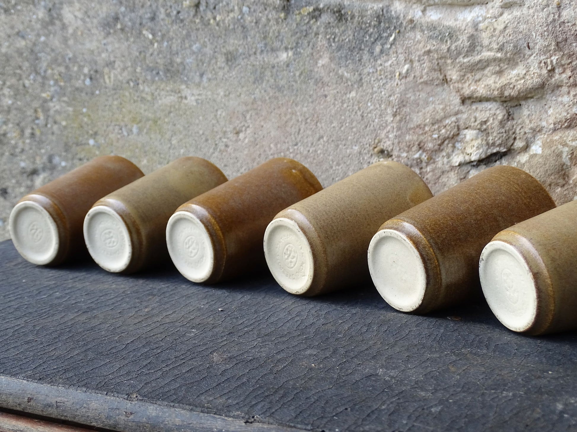 Set of six rustic vintage stoneware cups or pottery tumblers by Digoin in neutral tones. 