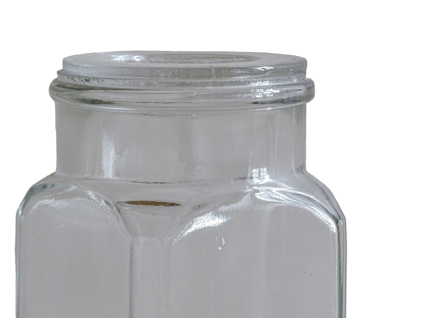 A French antique glass épicerie jar with original lid. Dating to circa 1920. It is made beautiful, thick pressed glass, embossed with the maker's name to the front and "Facile" to the top of the lid. 