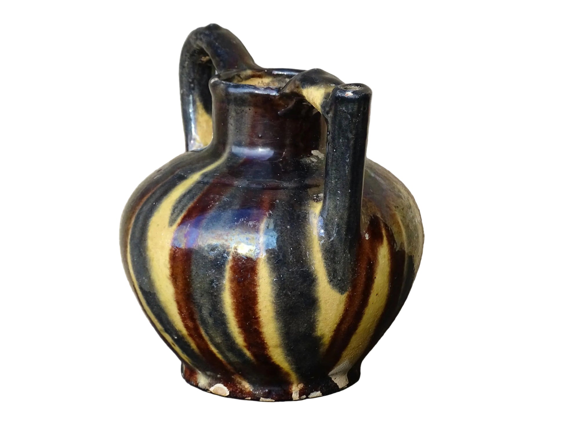 French antique ceramic jug or orjol with striped glaze. Glazed terracotta pitcher with yellow, black and brown glaze. 