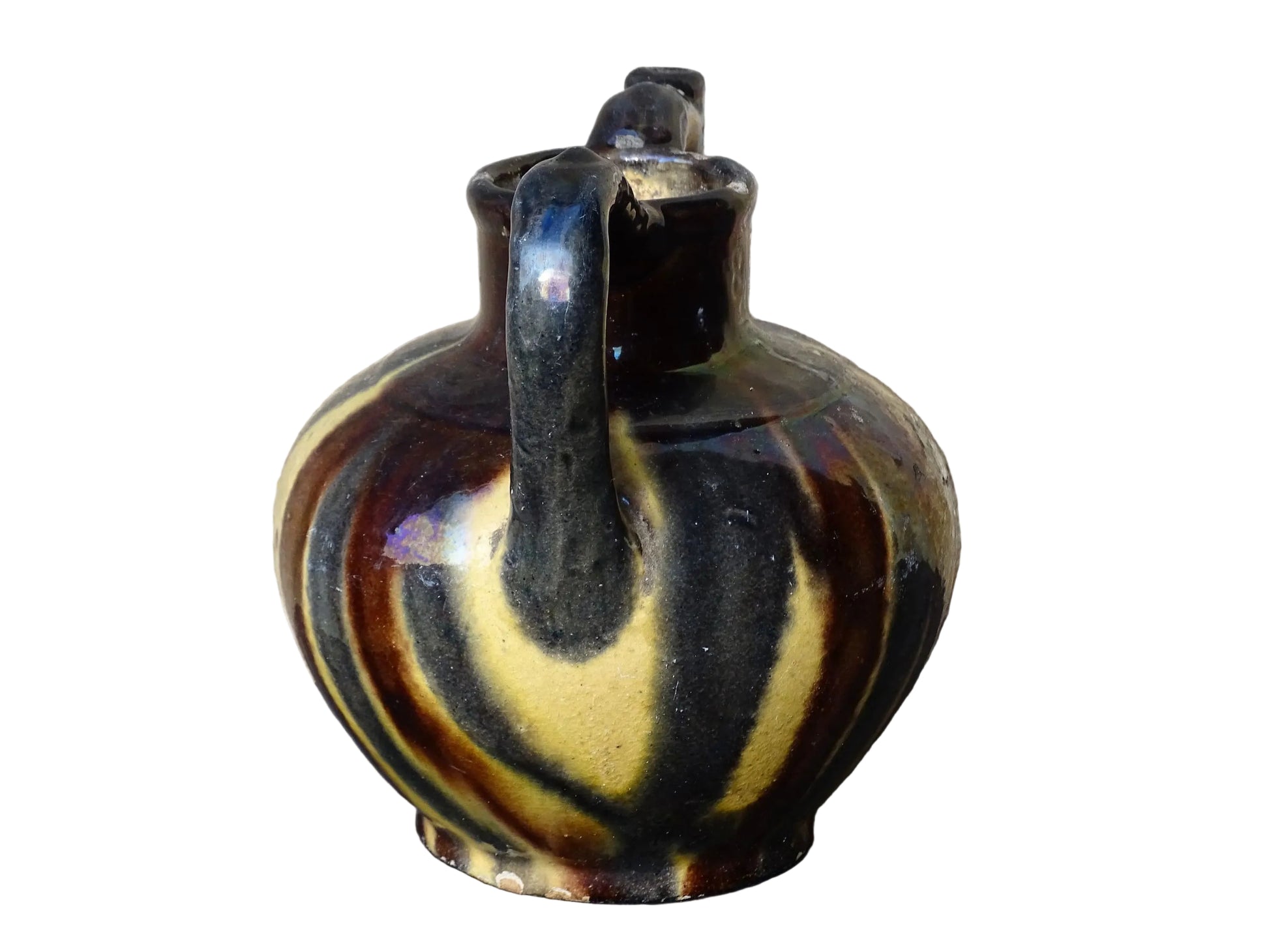 French antique ceramic jug or orjol with striped glaze. Glazed terracotta pitcher with yellow, black and brown glaze. 