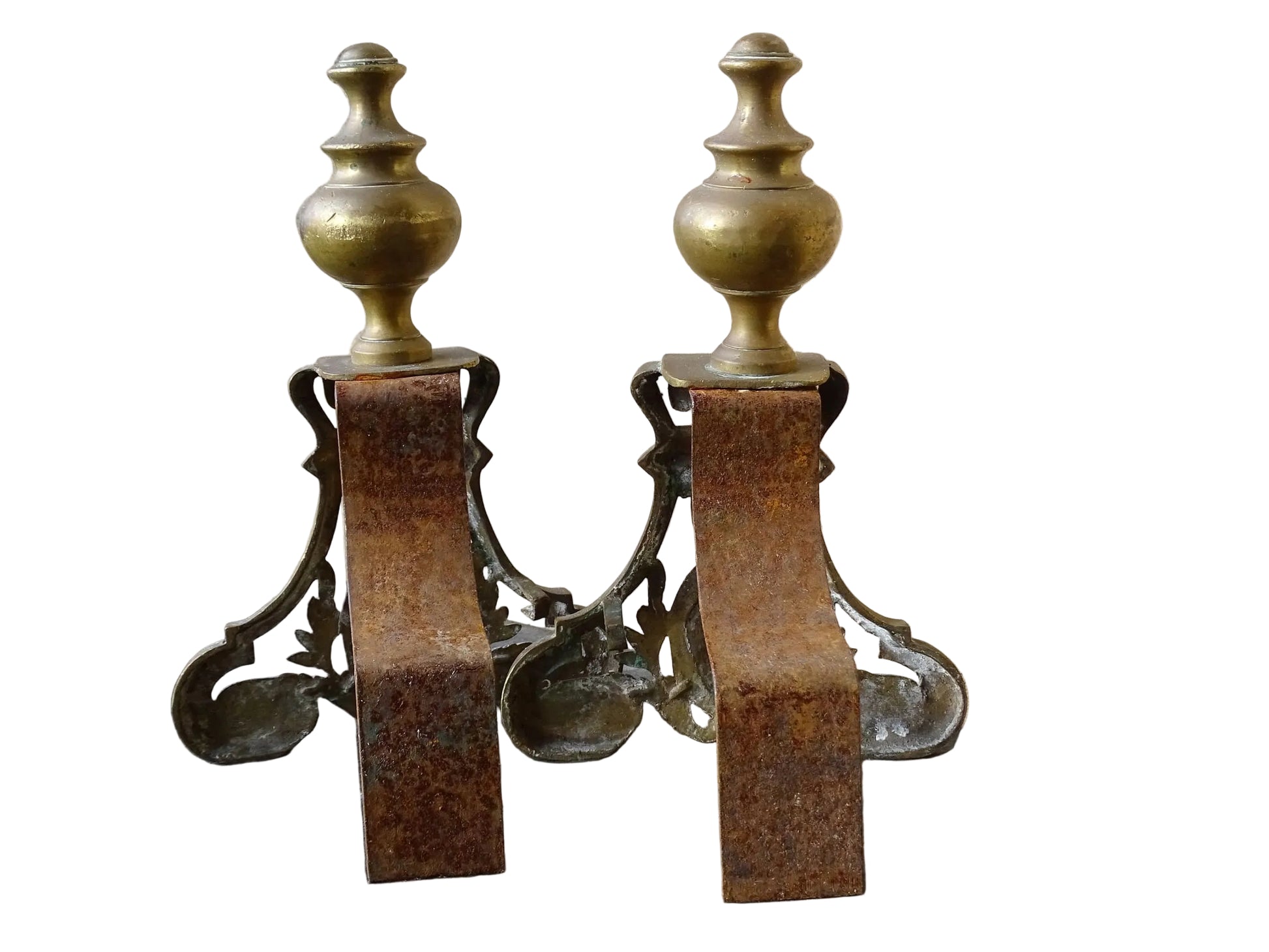 Pair of French antique brass andirons or fire dogs in a Louis XVI revival style. Each andiron is topped with a turned baluster finial. The pierced front plates display an ornate composition of acanthus leaves, scrollwork, and a central oval cartouche framed by laurel branches, typical of neoclassical design.