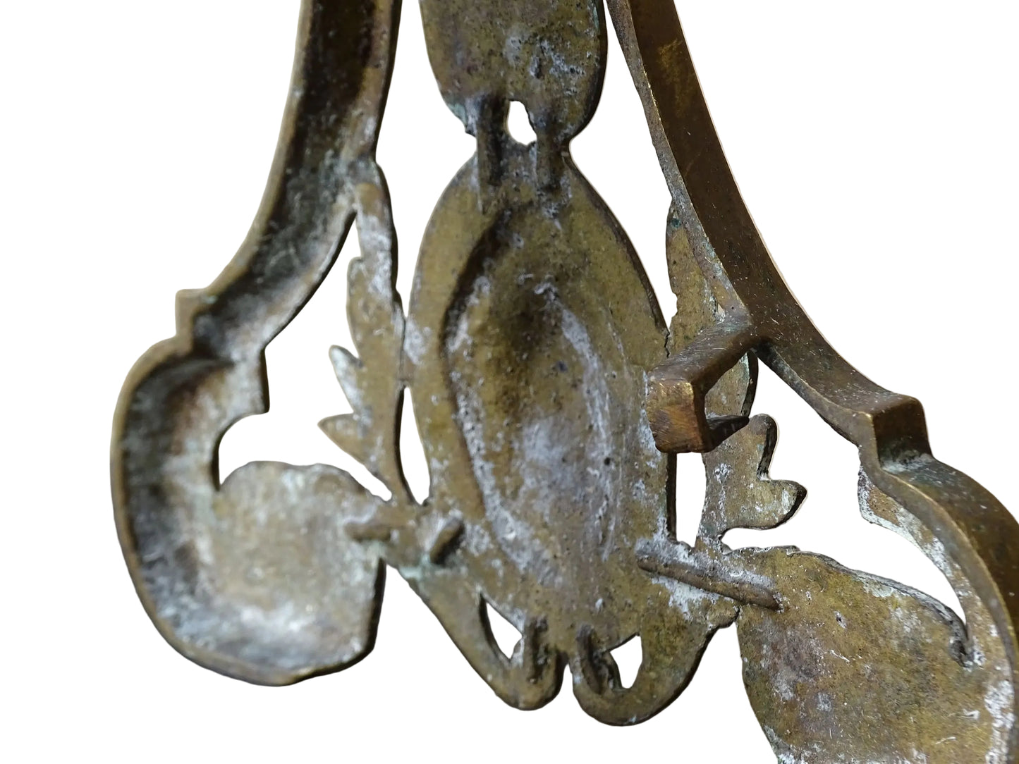 Pair of French antique brass andirons or fire dogs in a Louis XVI revival style. Each andiron is topped with a turned baluster finial. The pierced front plates display an ornate composition of acanthus leaves, scrollwork, and a central oval cartouche framed by laurel branches, typical of neoclassical design.