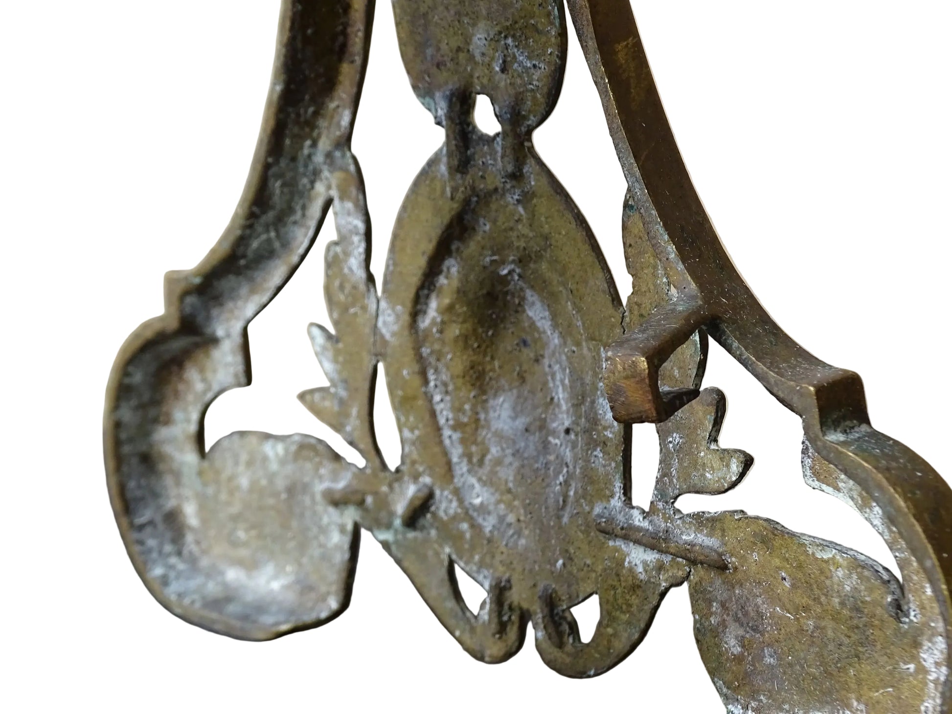 Pair of French antique brass andirons or fire dogs in a Louis XVI revival style. Each andiron is topped with a turned baluster finial. The pierced front plates display an ornate composition of acanthus leaves, scrollwork, and a central oval cartouche framed by laurel branches, typical of neoclassical design.