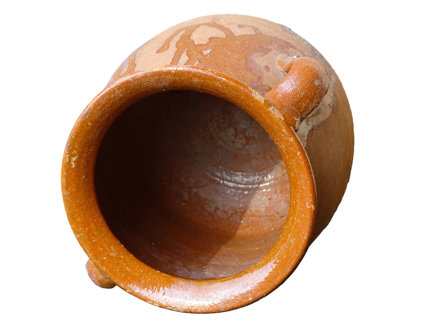 French vintage terracotta pot with orange glaze interior and drip glaze around the sides. Earthenware confit jar with two handles and a curved base.