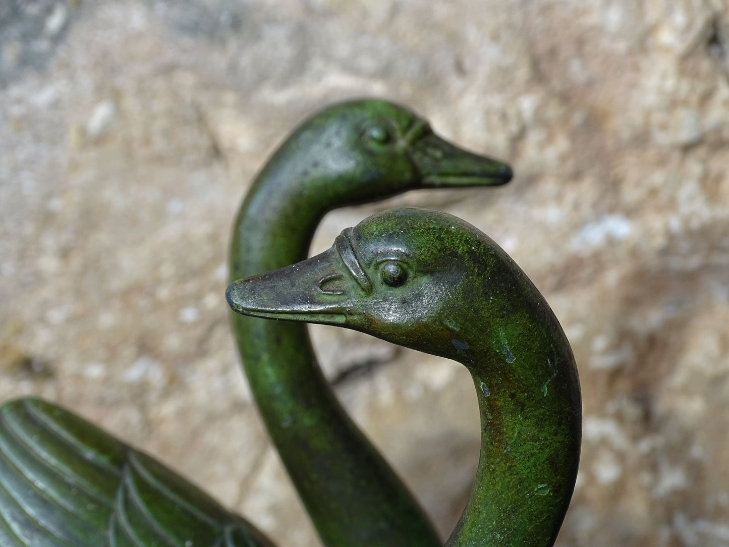 French vintage swan books on black marble bases. The swan statues have a green verdigris effect. 