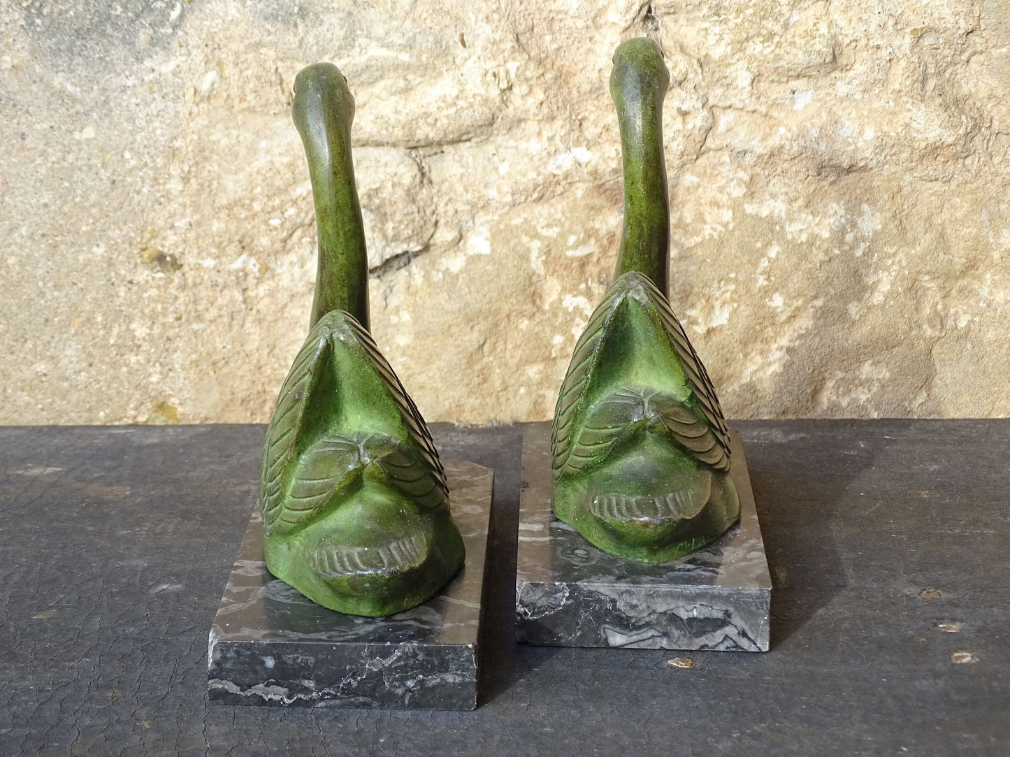 French vintage swan books on black marble bases. The swan statues have a green verdigris effect. 