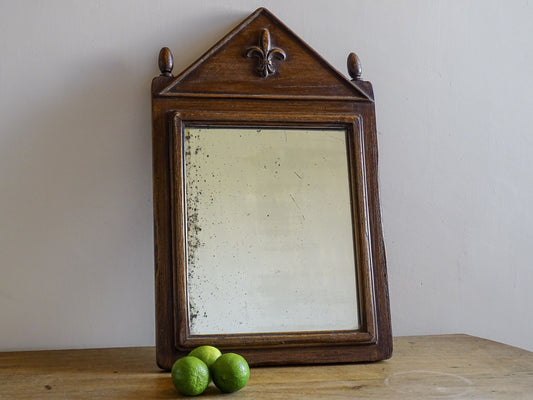French antique wooden mirror with finials and fleur de lys