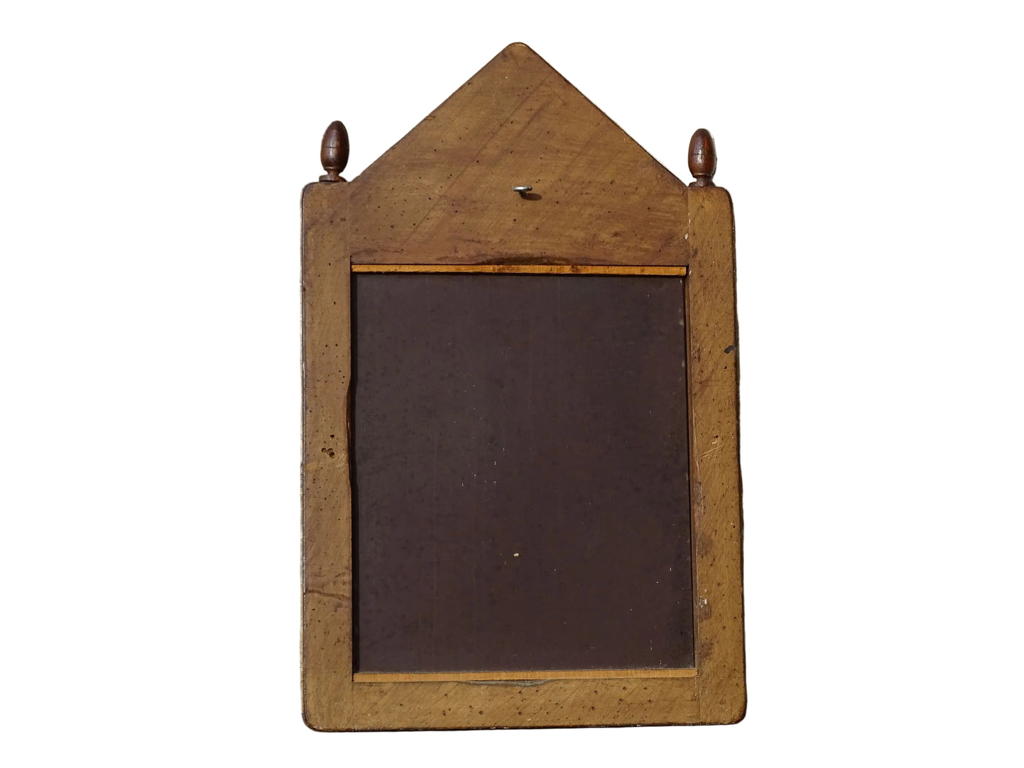 French antique wooden mirror with fleur de lis motif. The wood mirror is topped by a pediment with two turned finials.