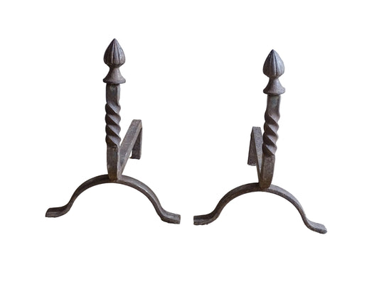 A pair of French antique cast iron andirons or firedogs. They date to the 19th century. They are beautifully aged and have acorn finials and barley twist detailing.