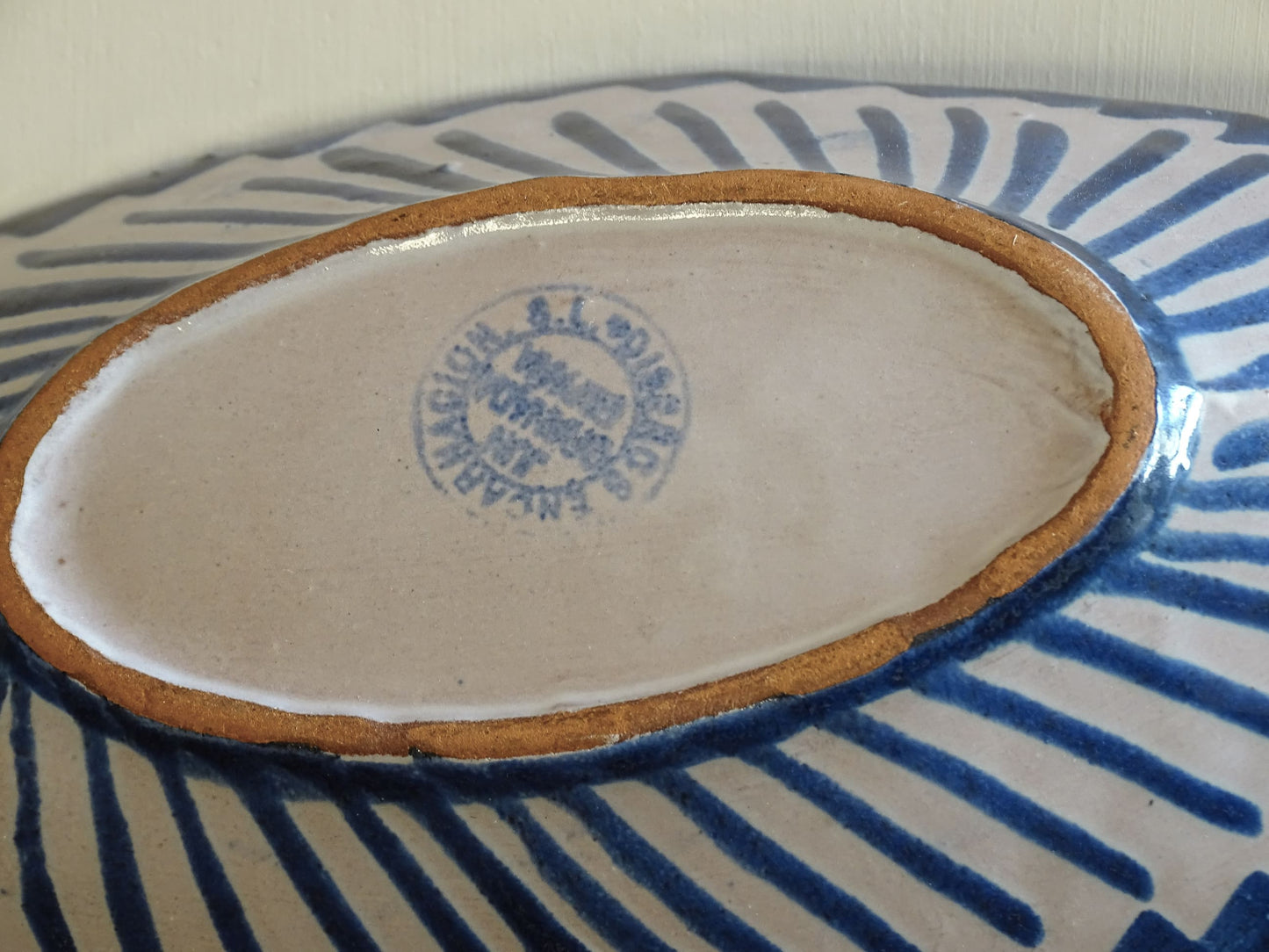A small Spanish vintage Fajalauza pottery trinket dish or bowl. Hand painted in blue. This beautiful terracotta piece has a pomegranate to the centre.