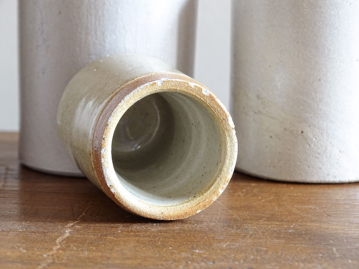 A set of seven small French vintage stoneware pots. This collection of pottery jars would look amazing as part of a rustic French farmhouse style home. Display in your kitchen as part of your shelf decor.