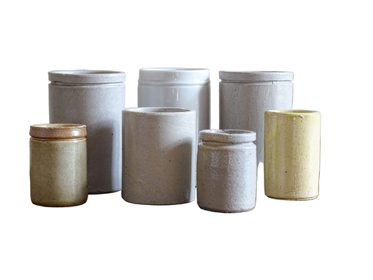 A set of seven small French vintage stoneware pots. This collection of pottery jars would look amazing as part of a rustic French farmhouse style home. Display in your kitchen as part of your shelf decor.