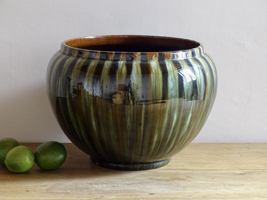 A large French antique Art Nouveau ceramic planter or jardiniere. This bulbous antique cache pot in terracotta, has a high gloss, flowing glaze in olive green, brown and black with vertical runs. Circa 1900. 