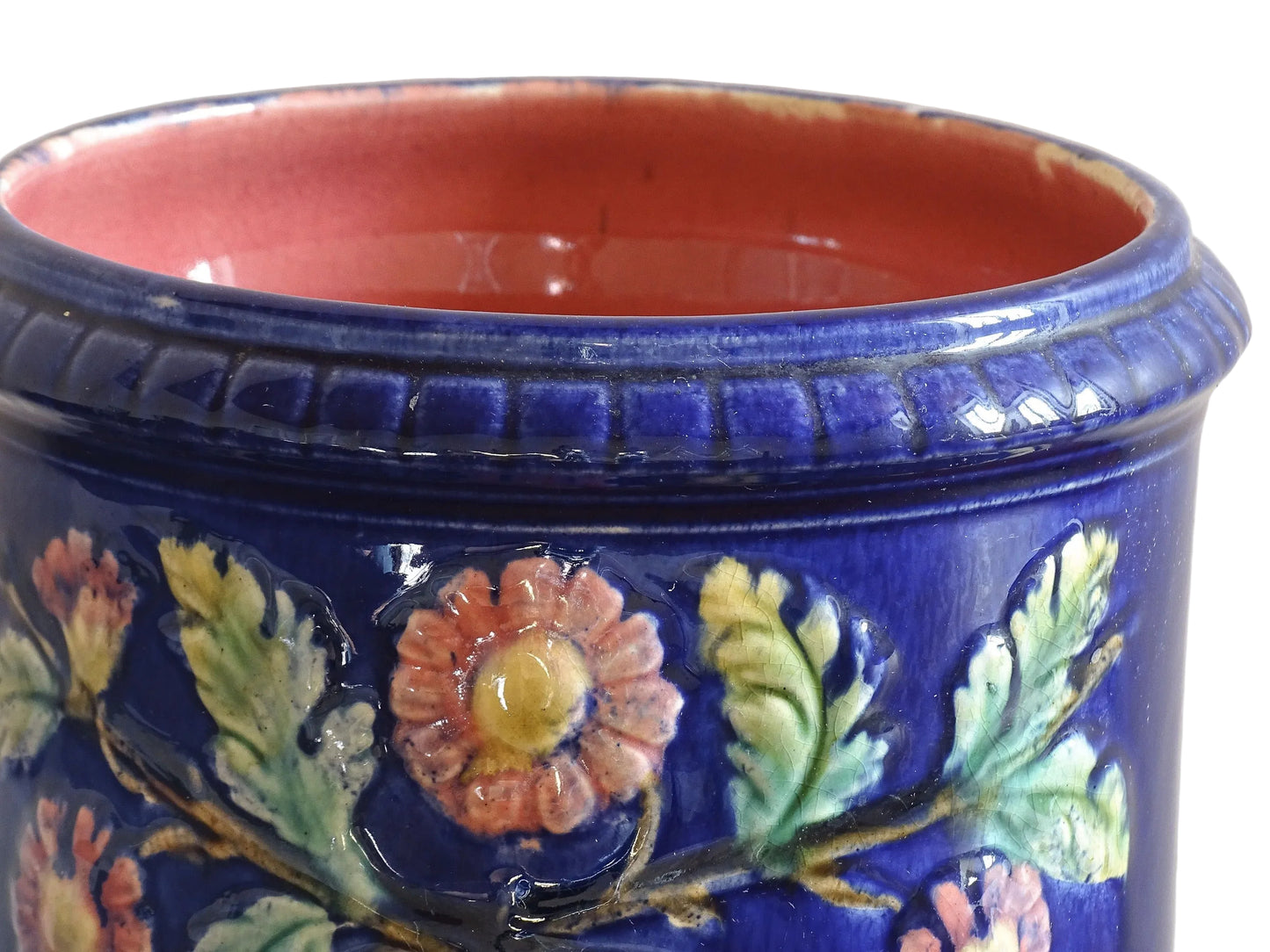 French antique barbotine ceramic planter. A lovely, cobalt blue cache-pot which is beautifully decorated with pink and yellow flowers along with green foliage.
