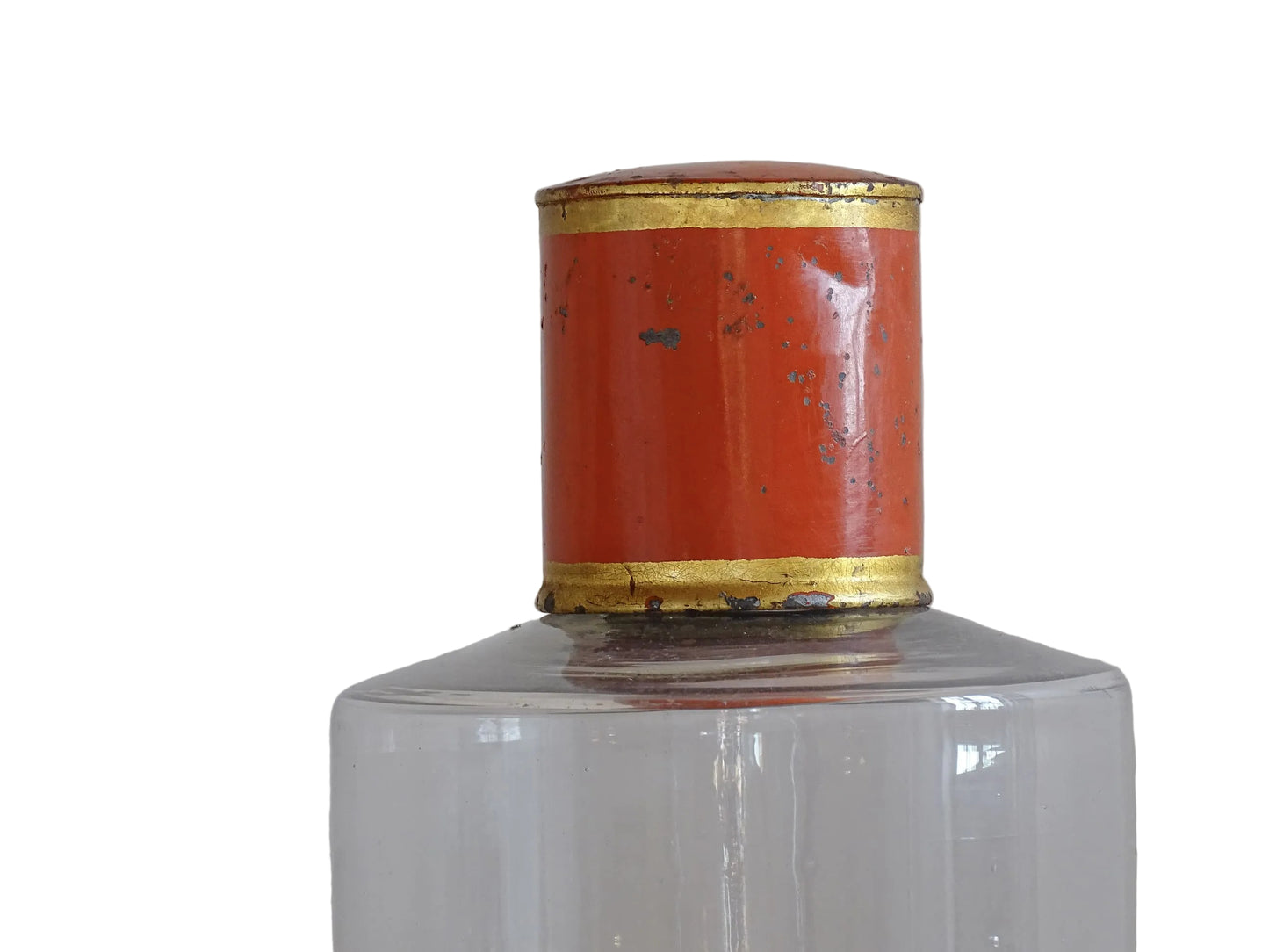 A French antique glass apothecary bottle with original, red and gold, painted metal top and original paper label. The label reads: Eau de Chaux (Lime Water). This antique glass bottle is hand blown and dates to the late 1800's. 