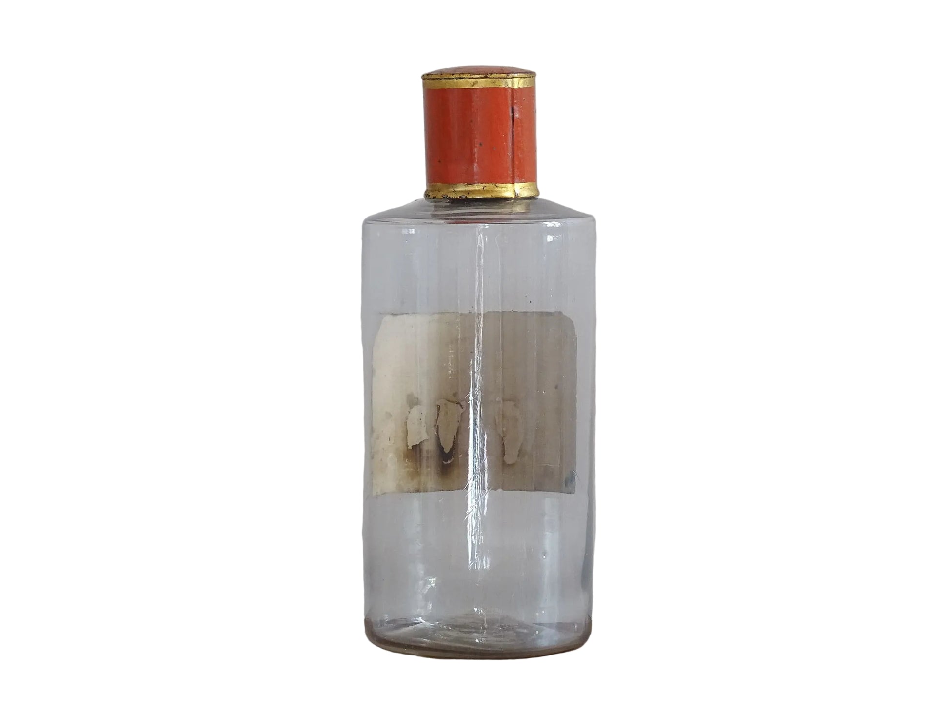 A French antique glass apothecary bottle with original, red and gold, painted metal top and original paper label. The label reads: Eau de Chaux (Lime Water). This antique glass bottle is hand blown and dates to the late 1800's. 