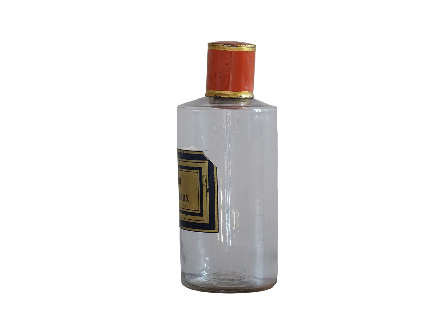 A French antique glass apothecary bottle with original, red and gold, painted metal top and original paper label. The label reads: Eau de Chaux (Lime Water). This antique glass bottle is hand blown and dates to the late 1800's. 