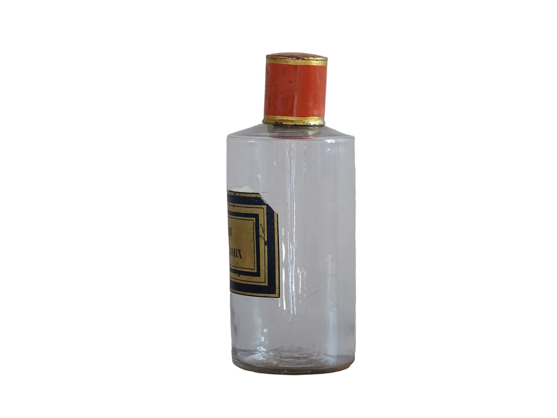 A French antique glass apothecary bottle with original, red and gold, painted metal top and original paper label. The label reads: Eau de Chaux (Lime Water). This antique glass bottle is hand blown and dates to the late 1800's. 