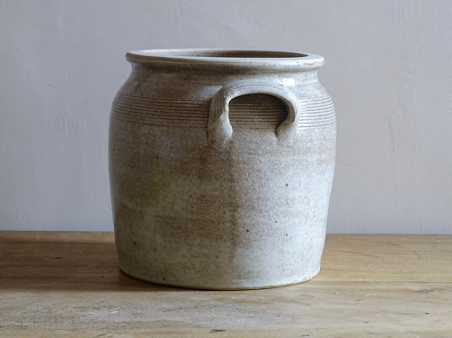 Large French antique stoneware confit pot with a grey beige glaze. This glazed pottery cache pot dates to the early 20th century and would look amazing as part of a rustic French farmhouse style home.