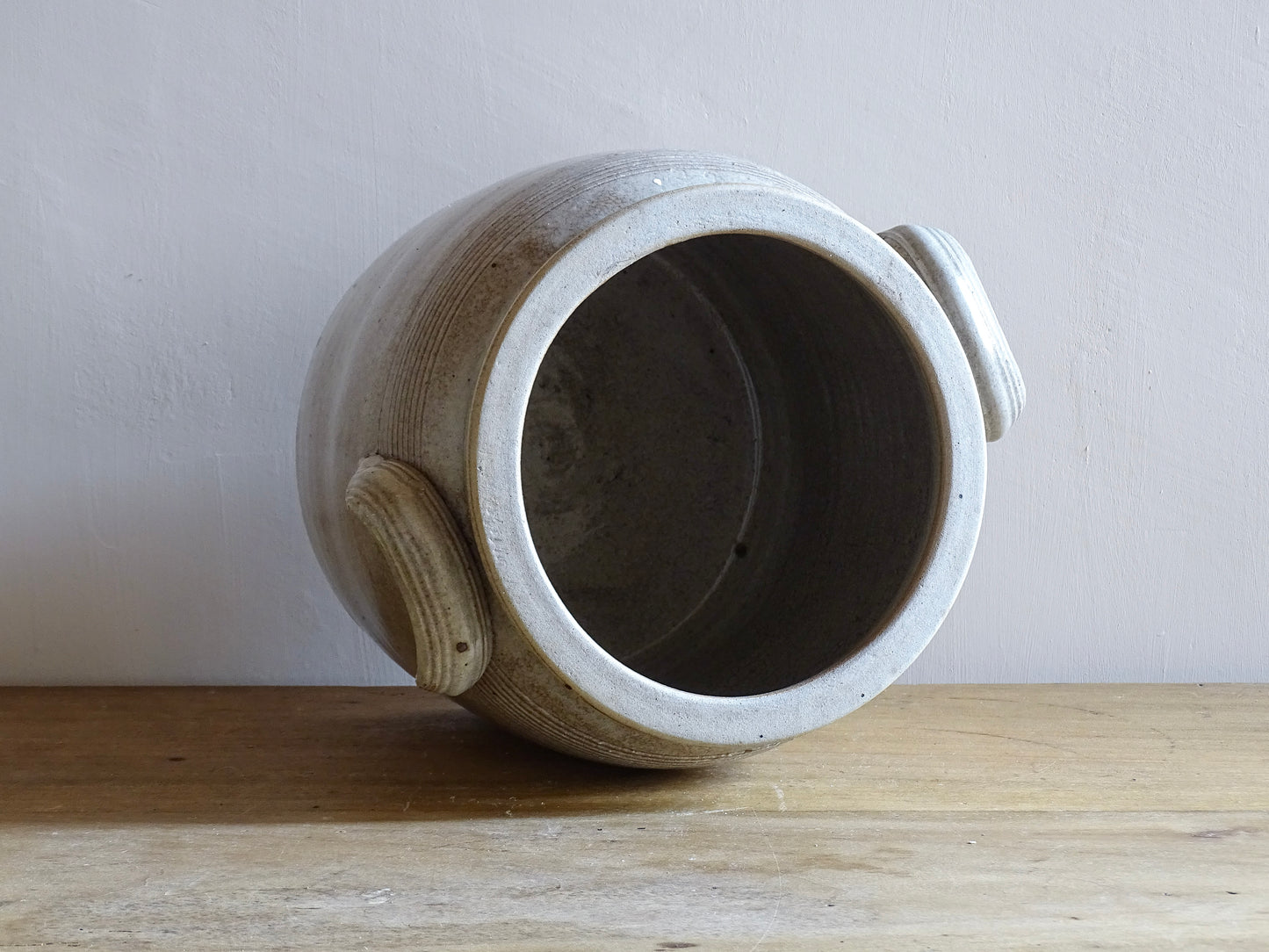 Large French antique stoneware confit pot with a grey beige glaze. This glazed pottery cache pot dates to the early 20th century and would look amazing as part of a rustic French farmhouse style home.