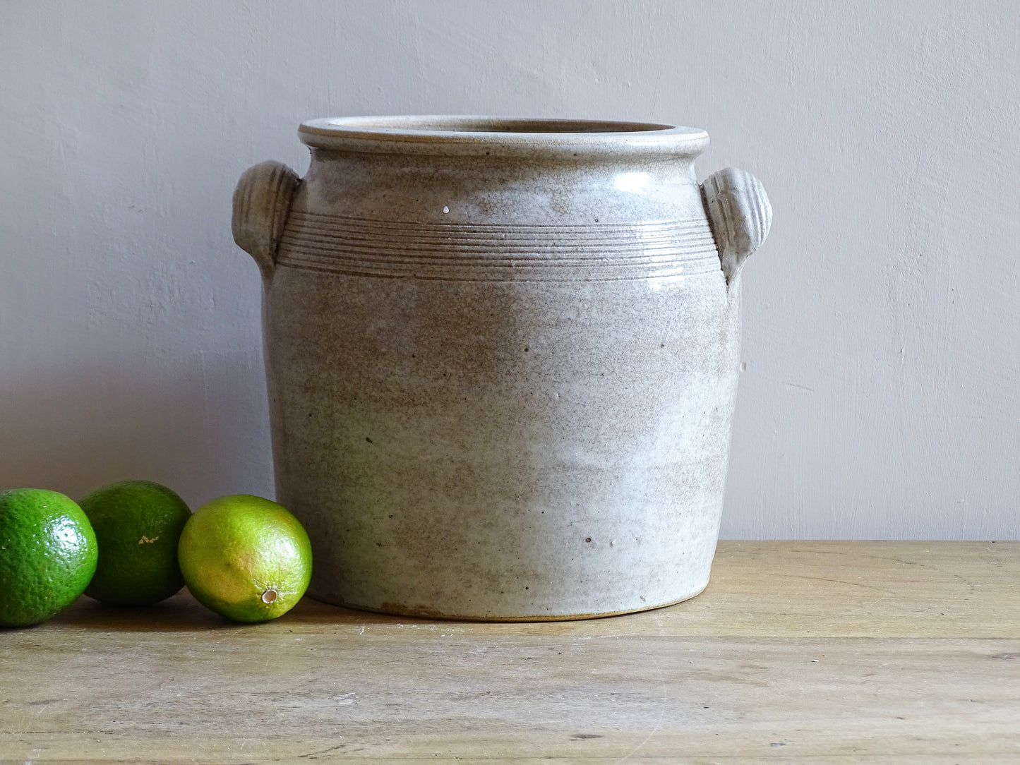 Large French antique stoneware confit pot with a grey beige glaze. This glazed pottery cache pot dates to the early 20th century and would look amazing as part of a rustic French farmhouse style home.