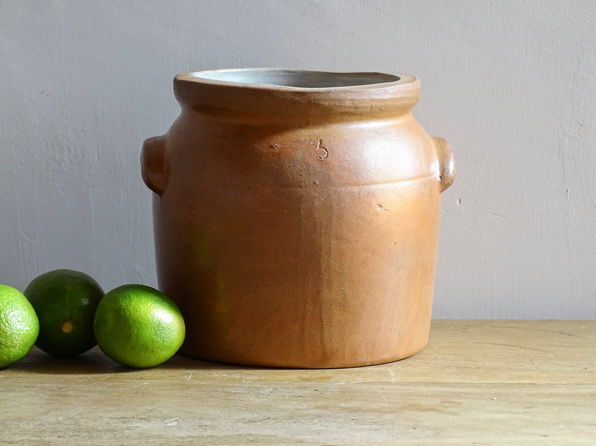 A French antique stoneware confit pot with a brown glaze. This salt glazed pottery cache pot dates to the early 20th century and would look amazing as part of a rustic French farmhouse style home. 