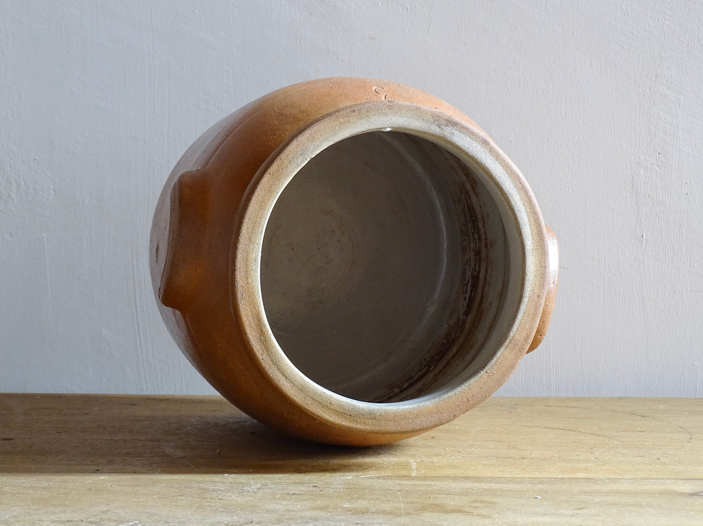 A French antique stoneware confit pot with a brown glaze. This salt glazed pottery cache pot dates to the early 20th century and would look amazing as part of a rustic French farmhouse style home. 