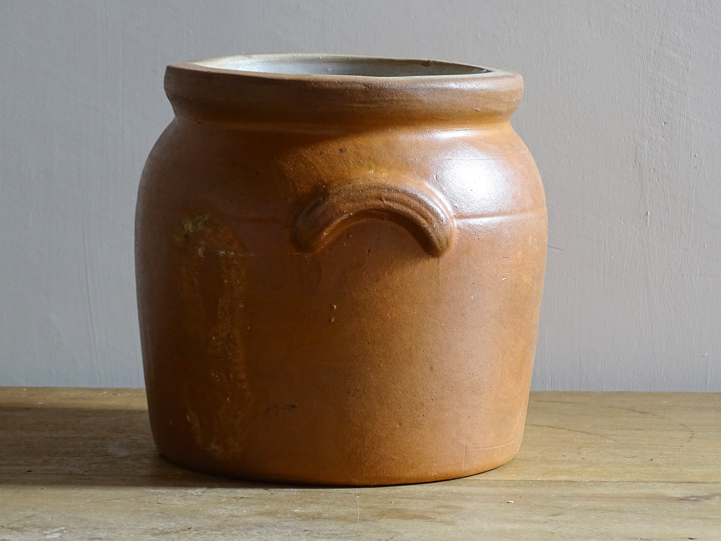 A French antique stoneware confit pot with a brown glaze. This salt glazed pottery cache pot dates to the early 20th century and would look amazing as part of a rustic French farmhouse style home. 