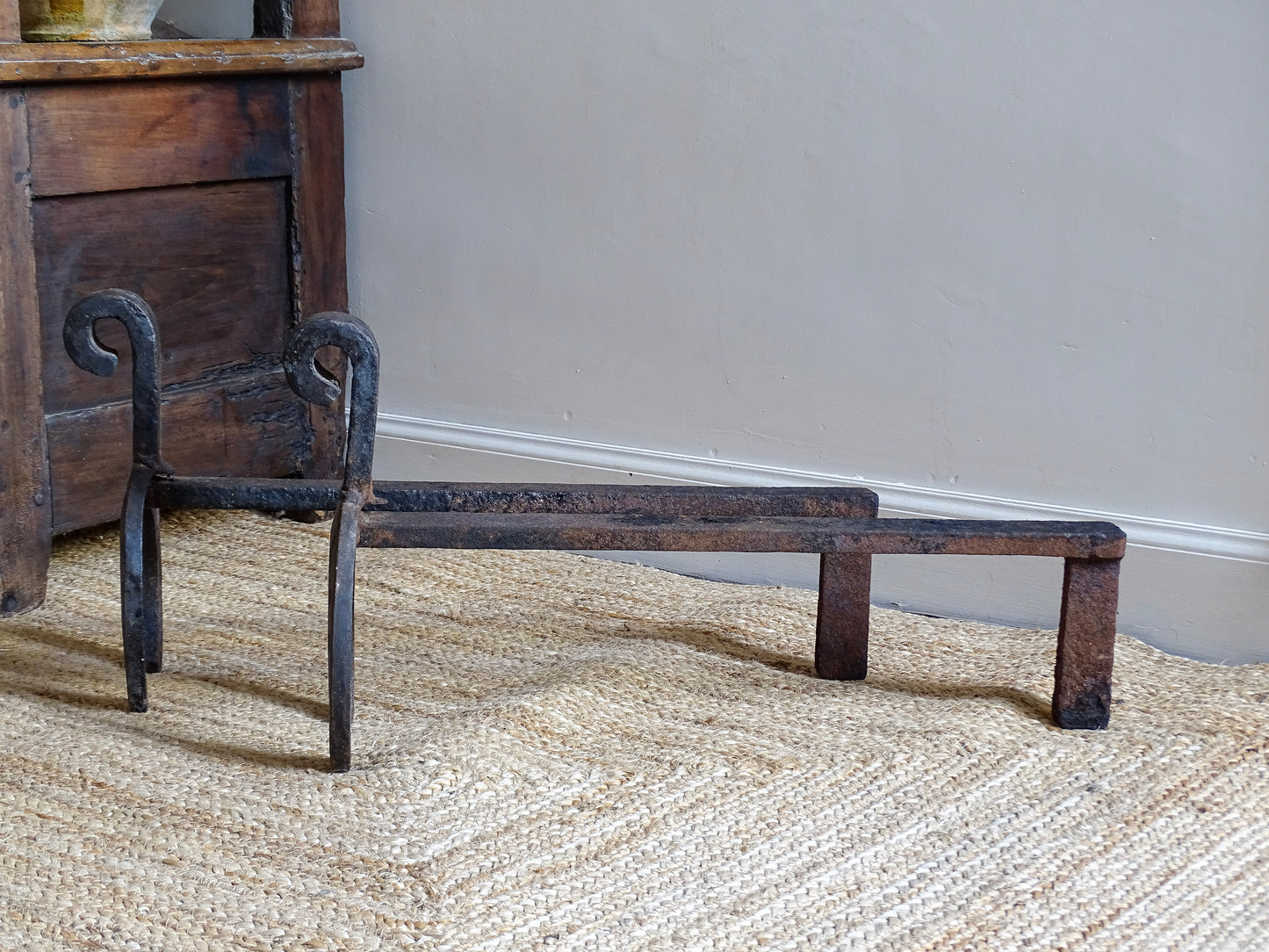  pair of French antique wrought iron andirons or fire dogs, date to the 19th century. They incorporate hand-forged horseshoes, with square-punched nail holes and substantial rear supports. A rustic, agricultural design with authentic forge marks throughout.