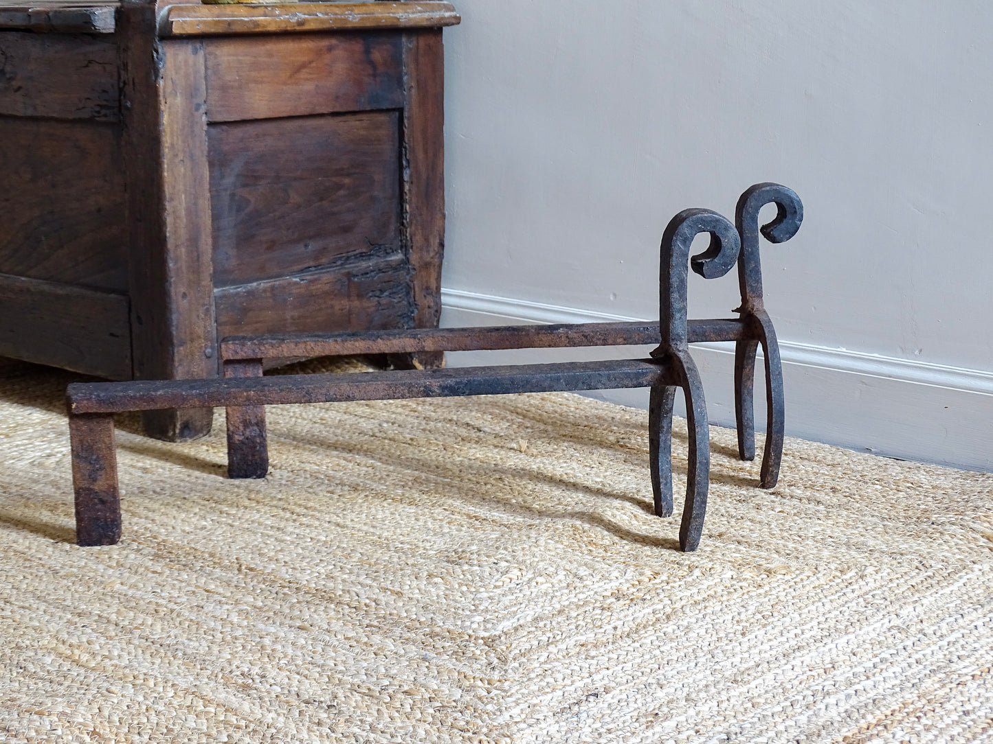  pair of French antique wrought iron andirons or fire dogs, date to the 19th century. They incorporate hand-forged horseshoes, with square-punched nail holes and substantial rear supports. A rustic, agricultural design with authentic forge marks throughout.