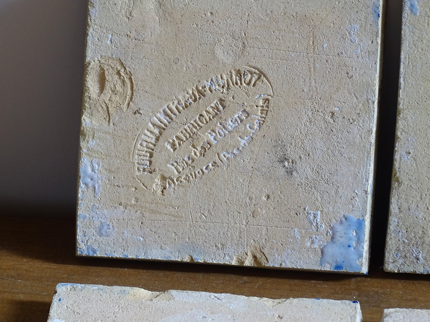 A set of eight French antique Desvres faience tiles in blue &amp; white. These transfer printed, earthenware tiles were manufactured in the late 1900's in Desvres, Northern France. Six of the tiles are back-stamped. They are beautifully transfer printed in cobalt blue. A floral sprig sits in the centre of the cartouche framing.