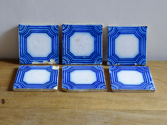 A set of six French antique Desvres faience tiles in blue &amp; white. These transfer printed, earthenware tiles were manufactured in the late 1900's in Desvres, Northern France. Five of the tiles are back-stamped. They are beautiful, transfer printed, architectural blue and white faience tiles with layered cobalt blue cartouche framing.