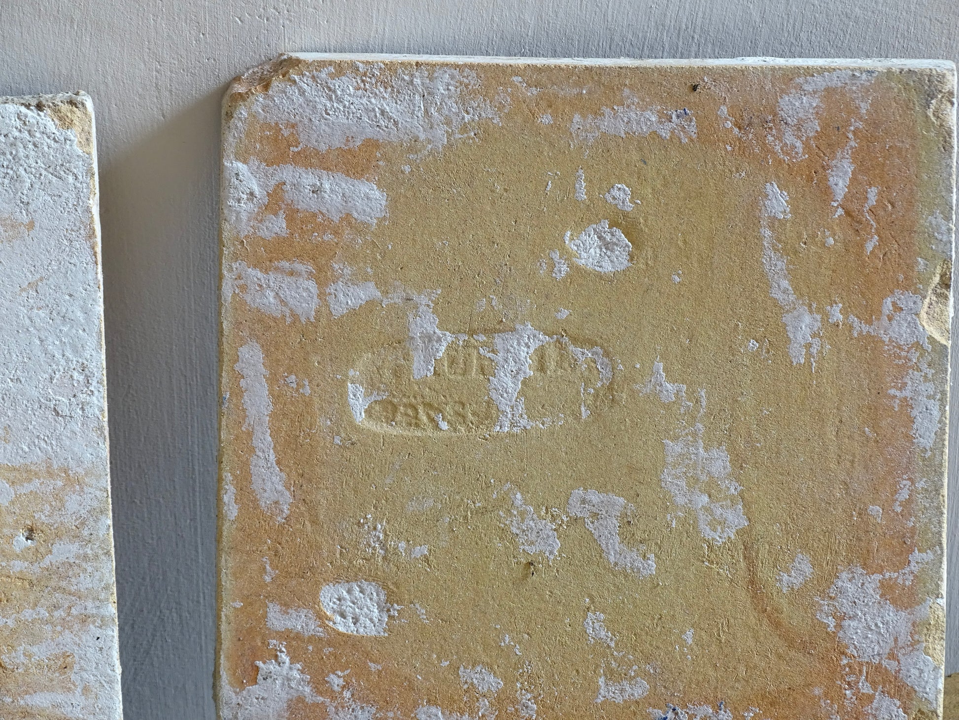 A set of three French antique Desvres faience tiles in blue &amp; white. These transfer printed, earthenware tiles were manufactured in the late 1900's in Desvres, Northern France. These antique tiles are back-stamped with the maker's mark. They are beautifully transfer printed in cobalt blue with a repeating Greek key motif and stylised wave border.