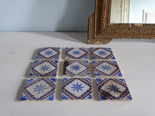 French antique earthenware tiles by Desvres with a blue, white and manganese glaze with star motif