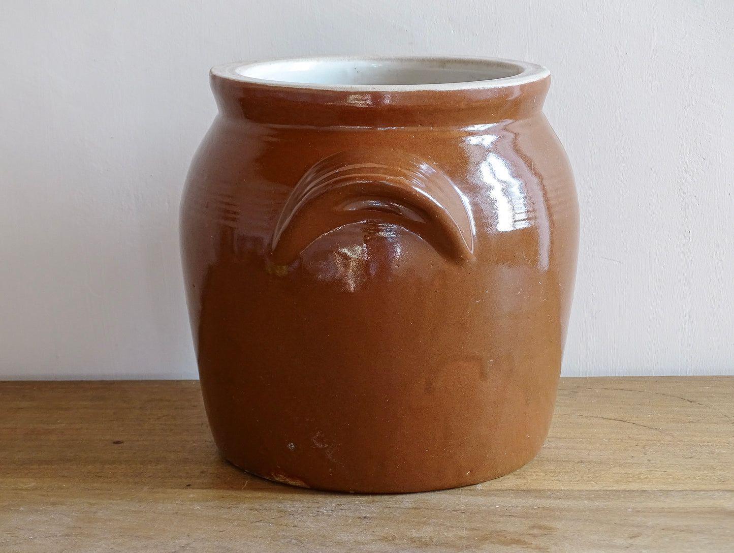 French antique stoneware preserving jar with a brown glaze. This pottery cache pot dates to the early 20th century and has a high gloss glaze.