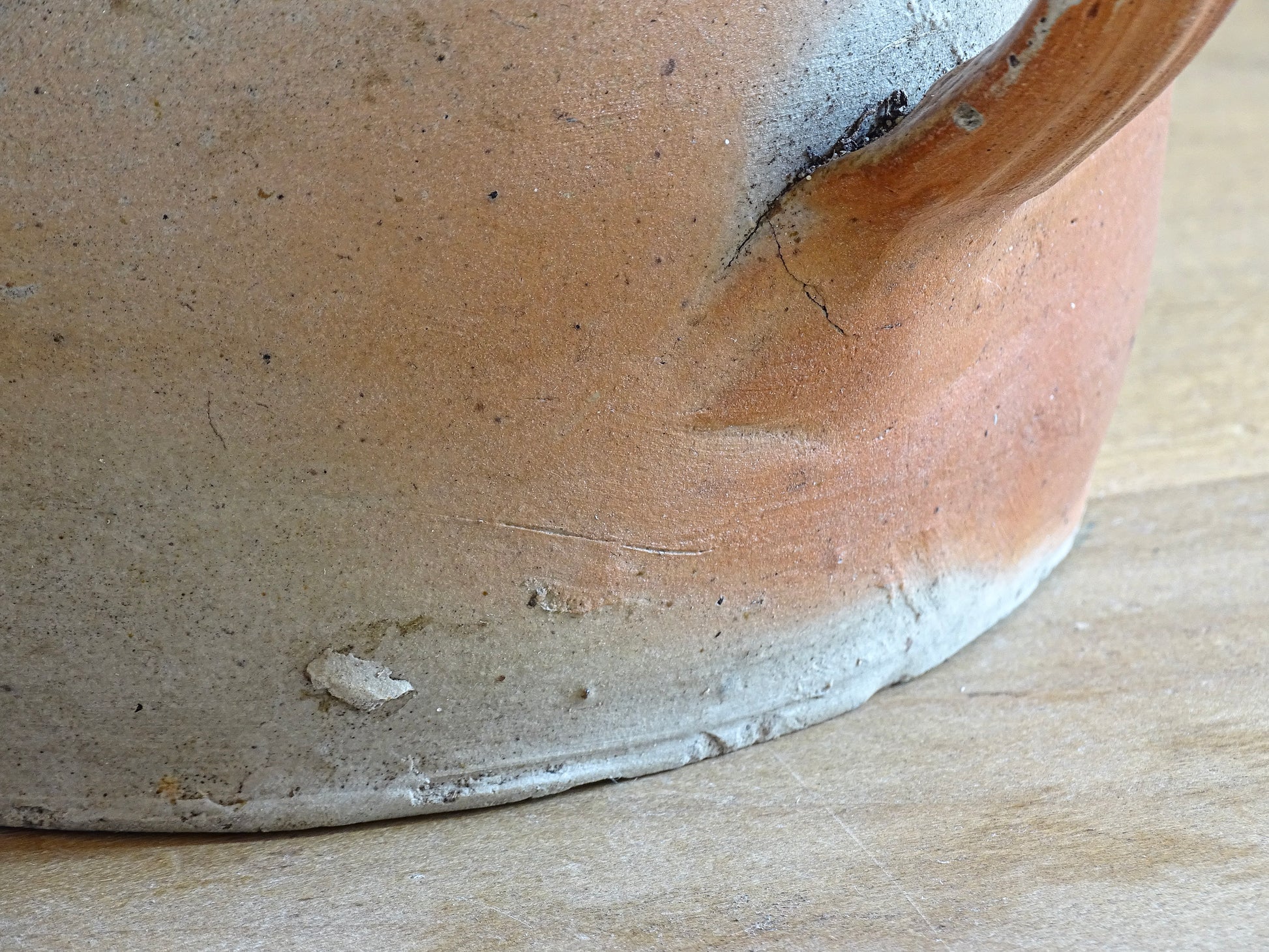 French antique stoneware jar with handle . This old confit pot with the colours of warm terracotta to pale hues is unglazed. It dates to the early 20th century. 