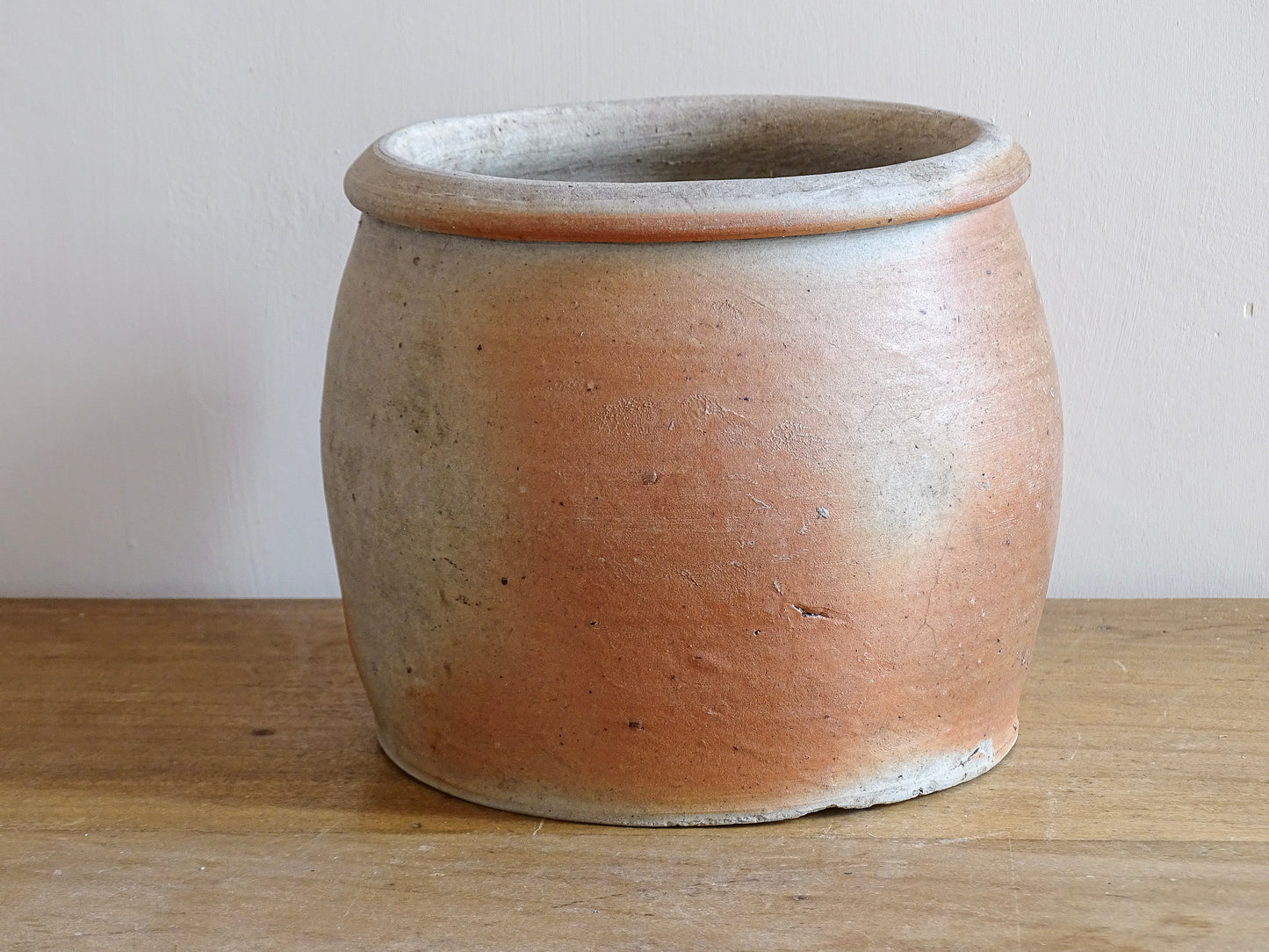 French antique stoneware jar with handle . This old confit pot with the colours of warm terracotta to pale hues is unglazed. It dates to the early 20th century. 