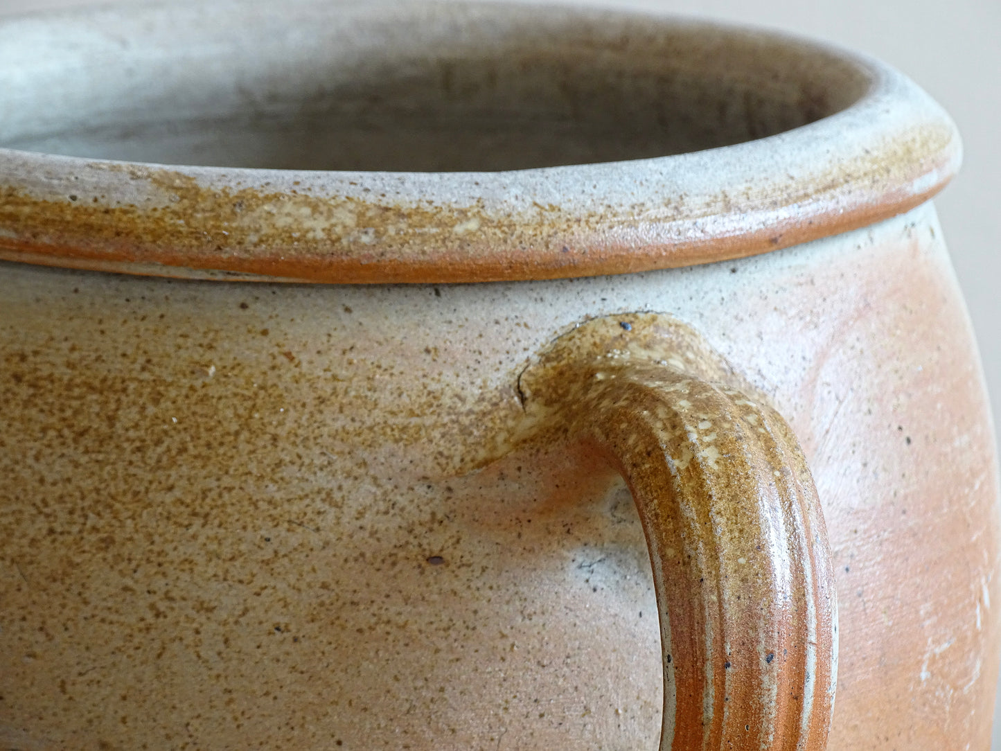 French antique stoneware jar with handle . This old confit pot with the colours of warm terracotta to pale hues is unglazed. It dates to the early 20th century. 