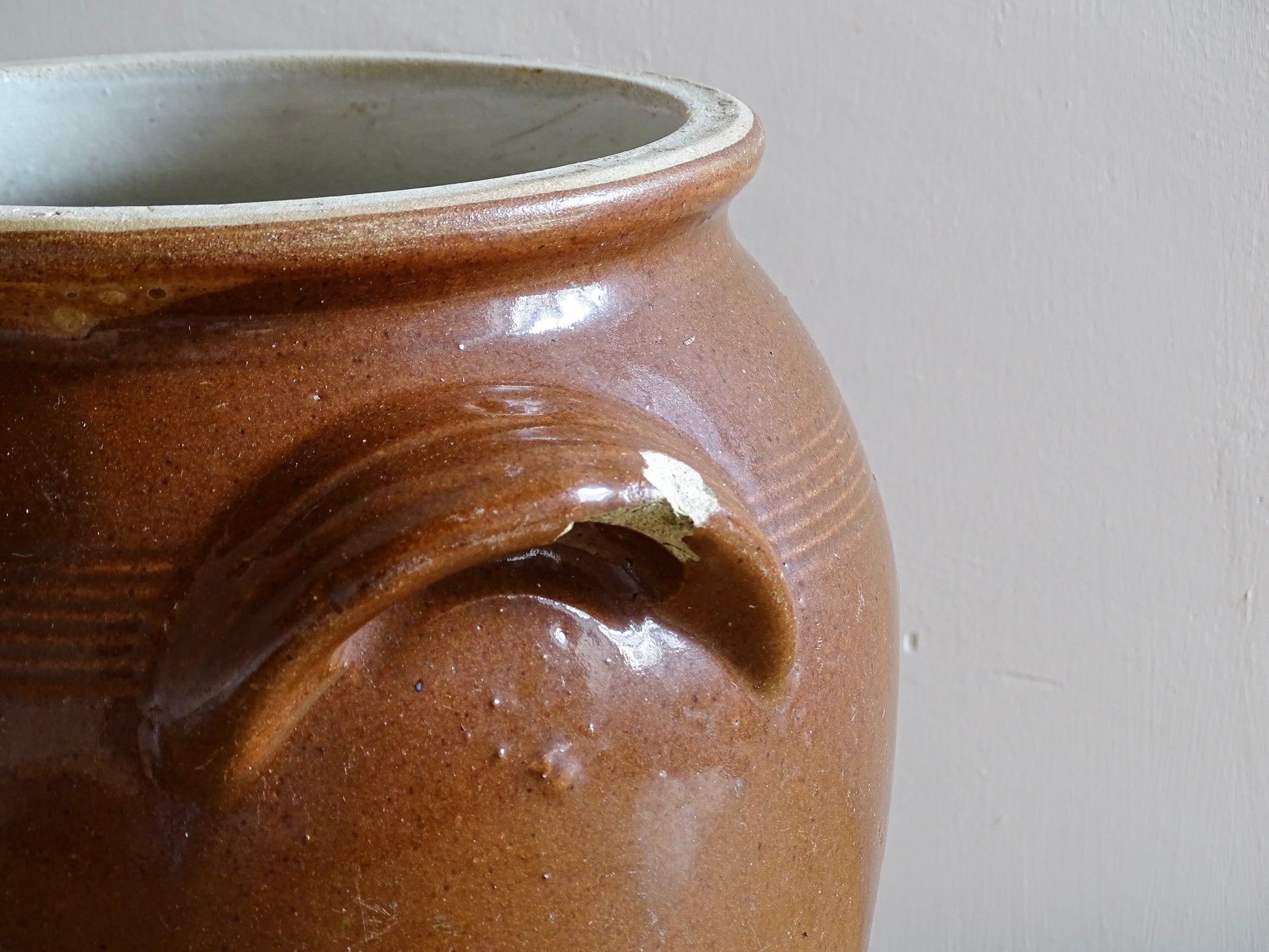 French antique stoneware preserving jar with a brown glaze. This pottery cache pot dates to the early 20th century and has a high gloss glaze. 