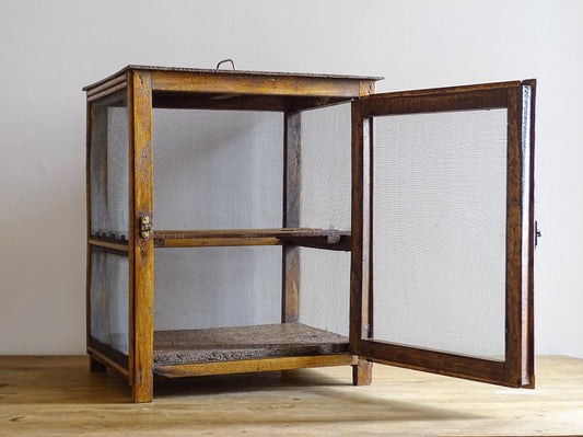 A French antique garde manger or countertop pantry cabinet. Circa 1920. This antique wooden garde manger with wire mesh panels on all sides was traditionally used for storing cheese, fruit, and baked goods while allowing air to circulate.