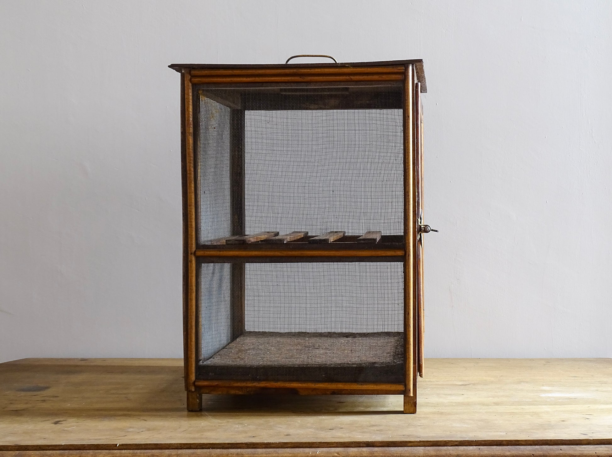 A French antique garde manger or countertop pantry cabinet. Circa 1920. This antique wooden garde manger with wire mesh panels on all sides was traditionally used for storing cheese, fruit, and baked goods while allowing air to circulate.