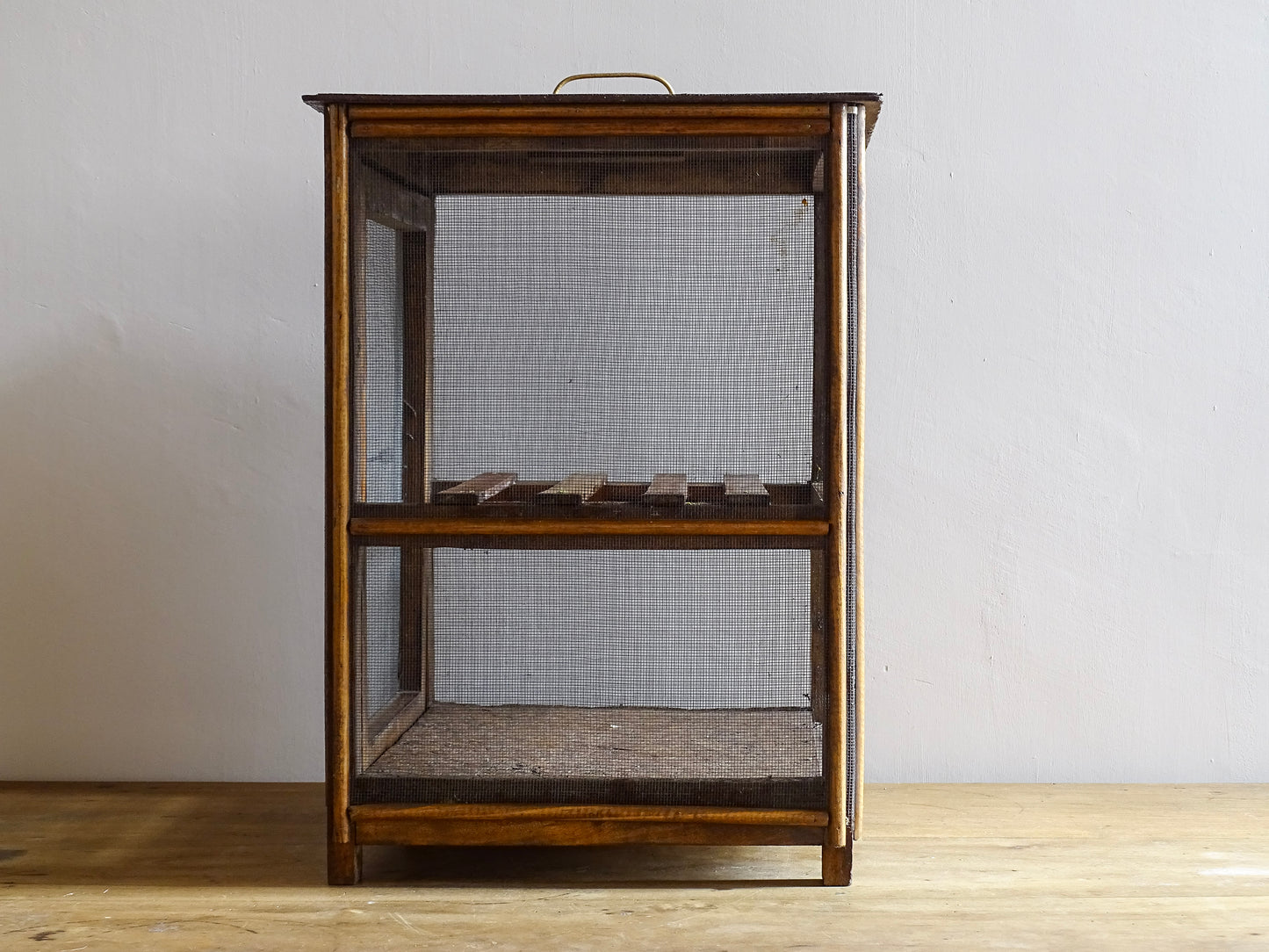 A French antique garde manger or countertop pantry cabinet. Circa 1920. This antique wooden garde manger with wire mesh panels on all sides was traditionally used for storing cheese, fruit, and baked goods while allowing air to circulate.