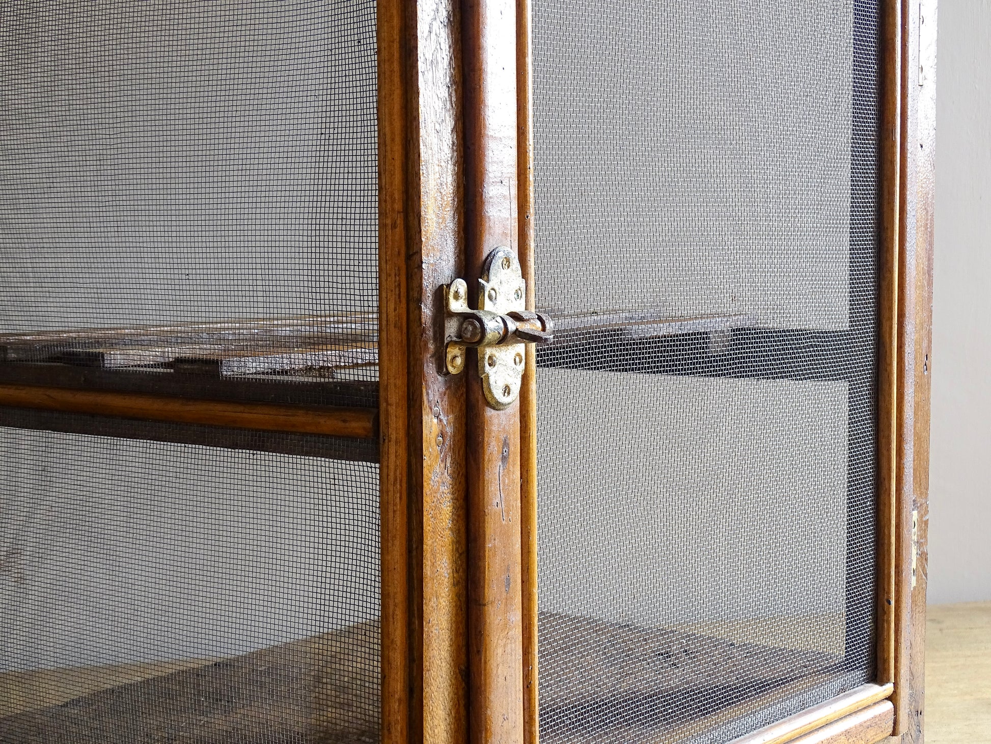 A French antique garde manger or countertop pantry cabinet. Circa 1920. This antique wooden garde manger with wire mesh panels on all sides was traditionally used for storing cheese, fruit, and baked goods while allowing air to circulate.
